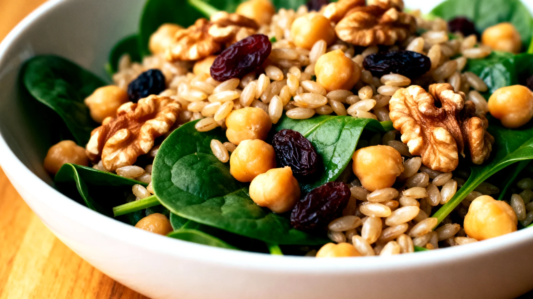 Insalata di farro con ceci, spinacini freschi, noci e uvetta"